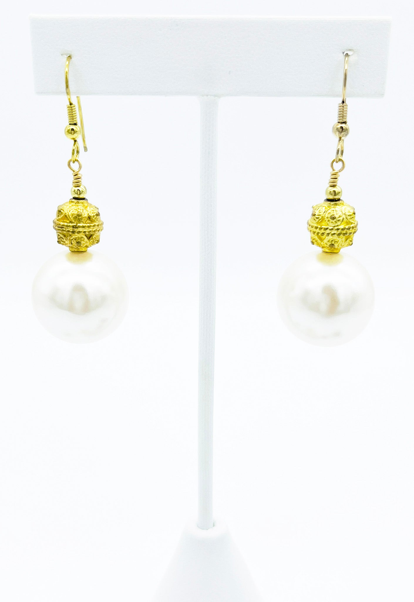 Close look at gold and pearl drop earrings