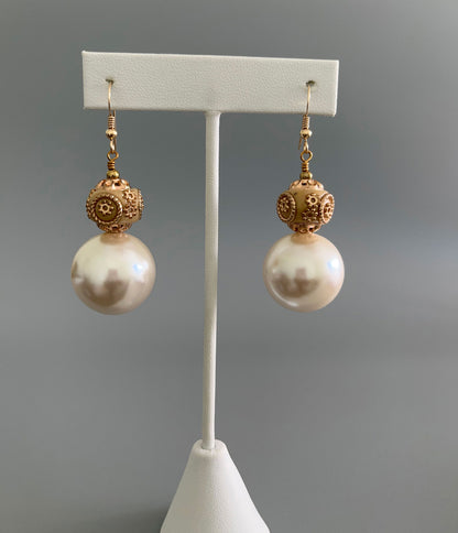 Closer view of resin and pearl drop earrings