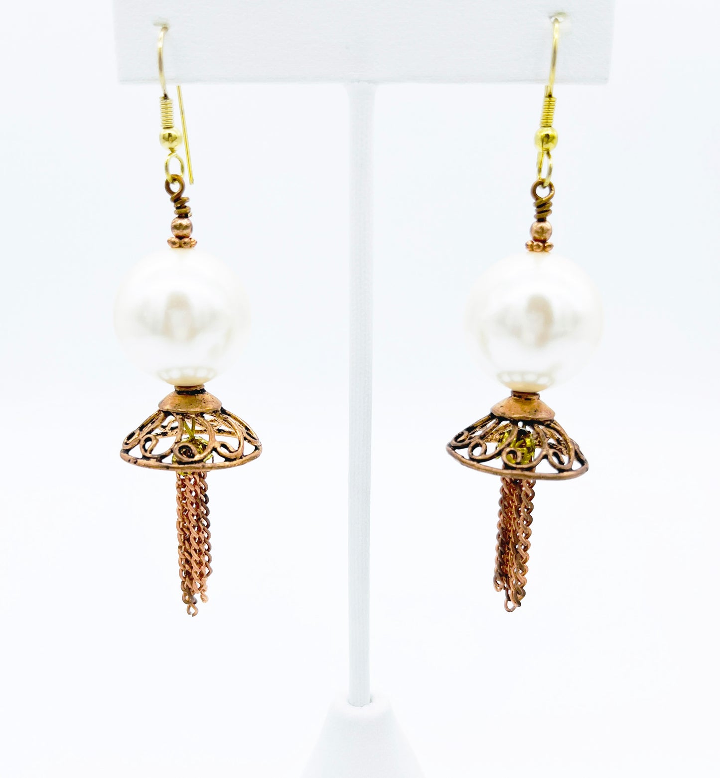 Close look at filigree and pearl copper dangle earrings
