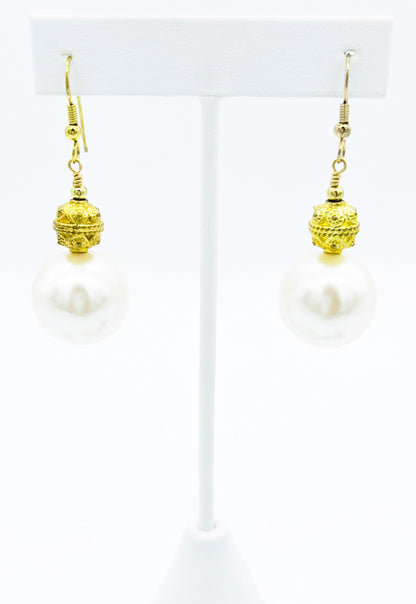 Close look at gold and pearl drop earrings