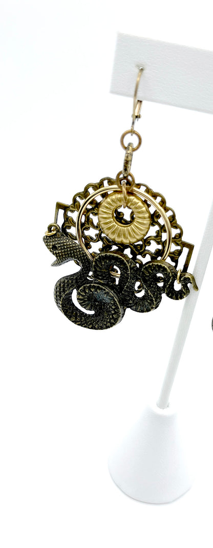 Close up of  brass filigree serpent earrings