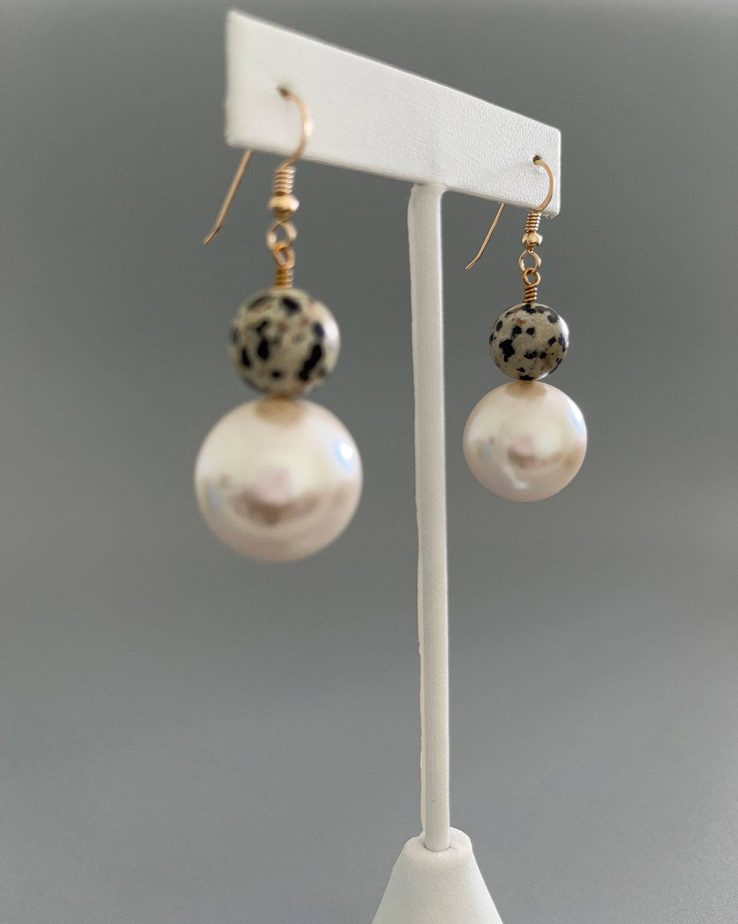 Side view of leopard jasper and pearl earrings