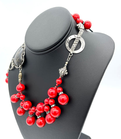 Close up of silver toggle on vintage red beaded necklace